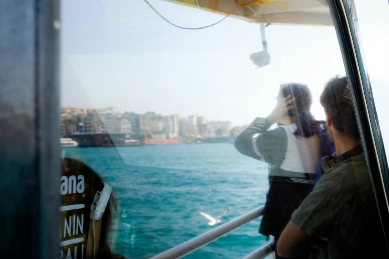 a man and woman are on the deck of a ship