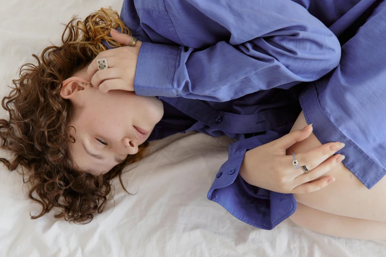 a woman laying down on her stomach on a bed