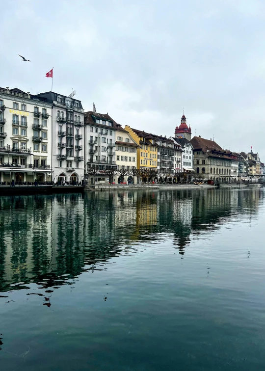 a row of buildings on the shore of a lake