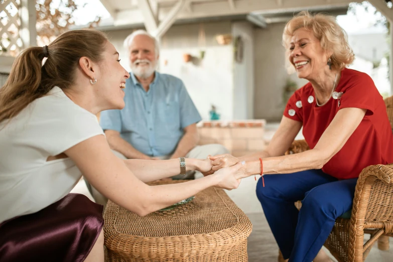 a woman in red is holding hands with an older lady