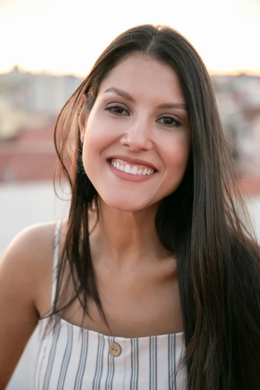 woman wearing a blue striped shirt smiling