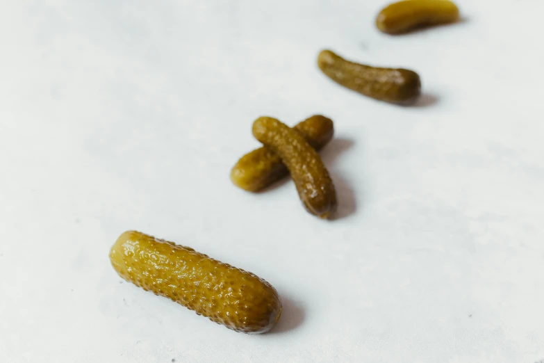 the three small cucumbers are laying out on the table