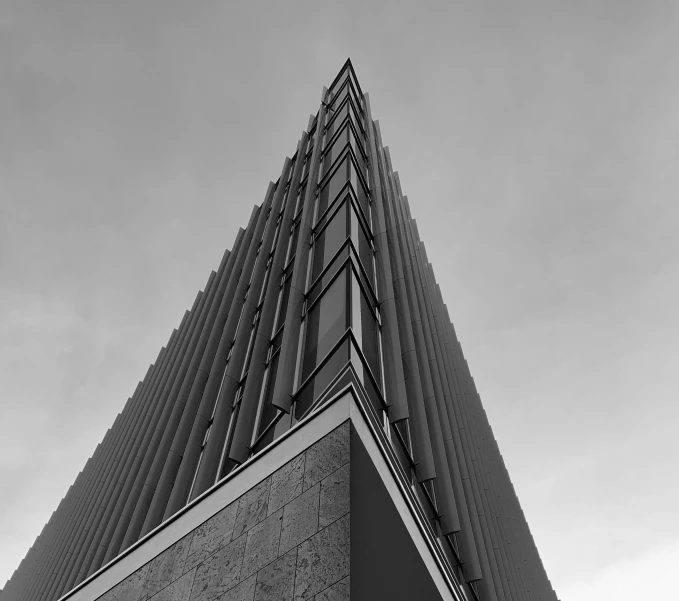 the side of a tall, glass - framed building