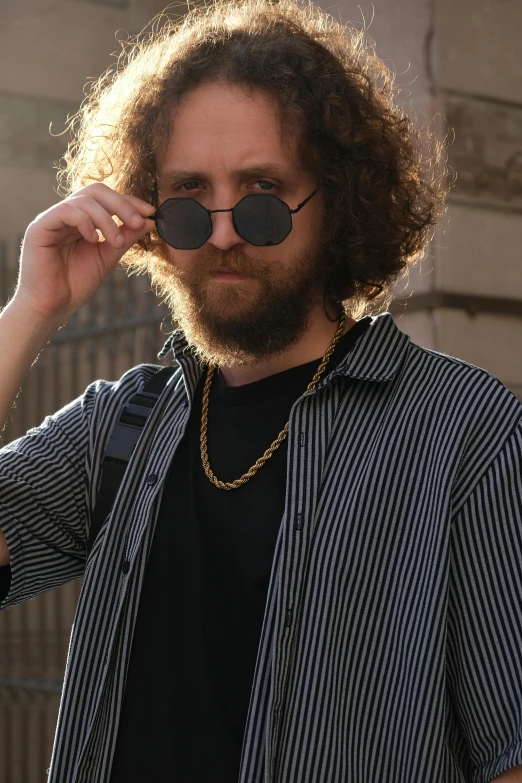 a man with a beard wearing sun glasses