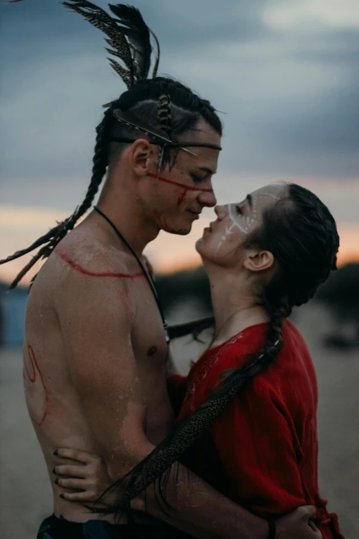 man and woman in costume kiss each other