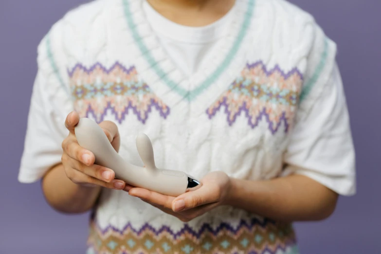 a close up of someone holding some video game controllers