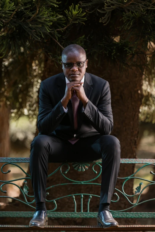 a man is sitting on the bench outside