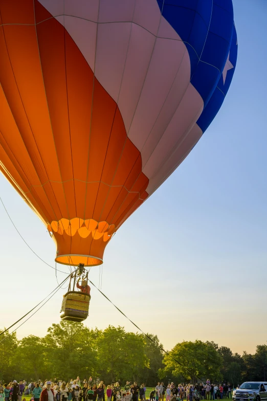 a large balloon floating above a crowd of people