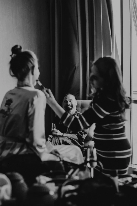 a young woman sits in front of a mirror and brushes her teeth