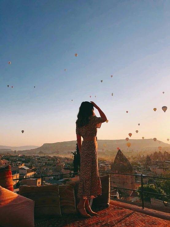 there is a woman sitting on top of a building