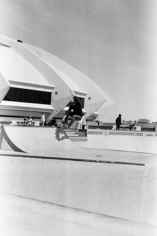 skateboarders at the top of an elevated ramp