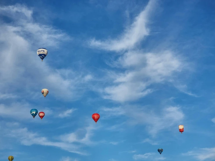  air balloons in the sky are all floating together