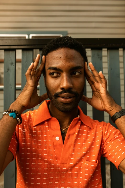 an african american man adjusts his hairs