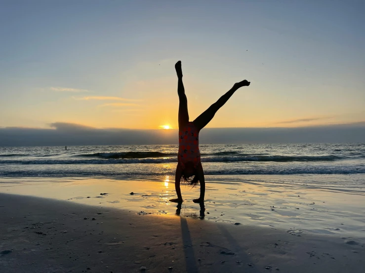 a person doing some tricks on a beach