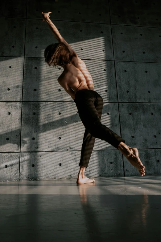 the dancer is dancing on the tiled floor