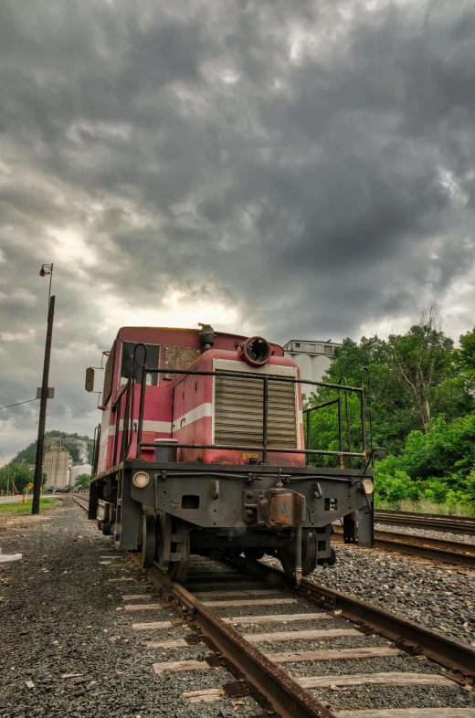 an old abandoned train sitting on the tracks