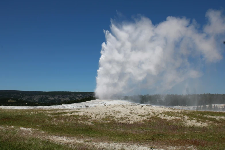 a geyser spewing water from a river