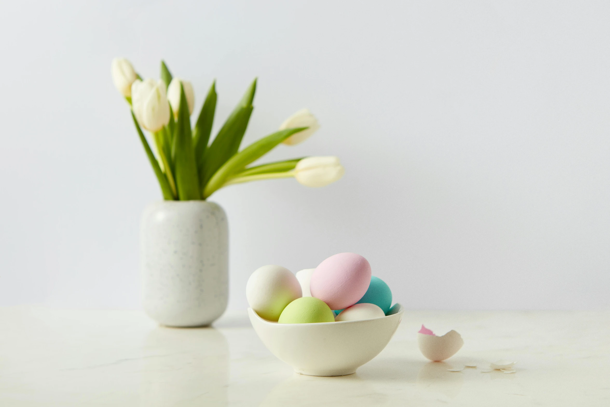 a white bowl with eggs in it sitting on a table