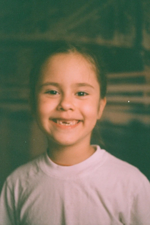 a  smiles in front of a green and white wall