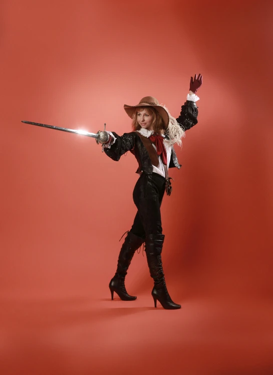 a lady in a costume holds a gun