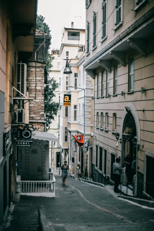 a city street is empty with people walking down the sidewalk