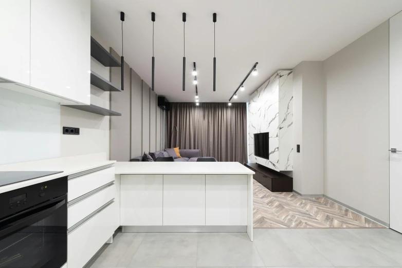 a modern kitchen with a white island and black appliances