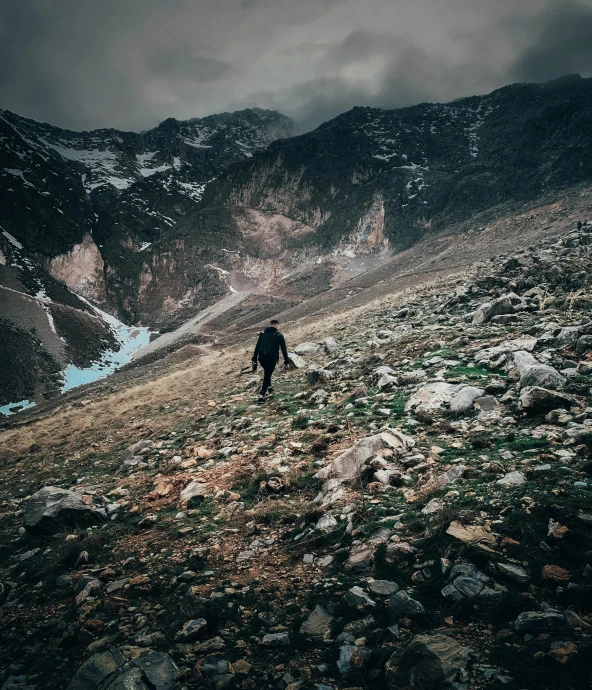 a person stands alone in the middle of the mountains