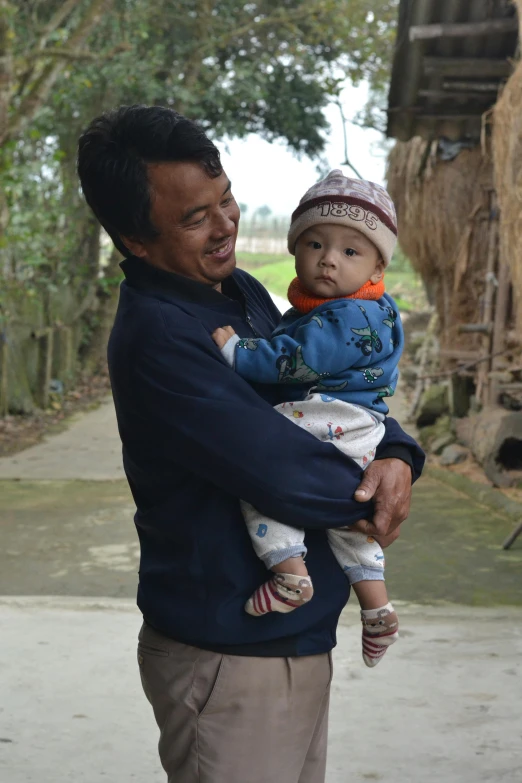 a man holding a child in his arms