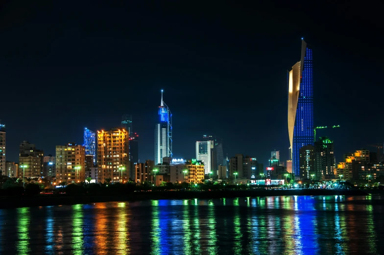 the city lit up at night, and reflected in the water