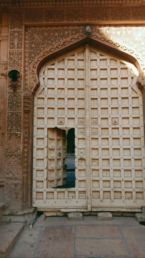 the doors are made of wood with decorative carvings