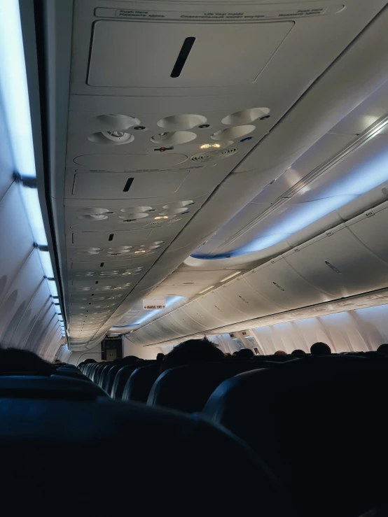 light streams down from the ceiling into the area on a large airplane