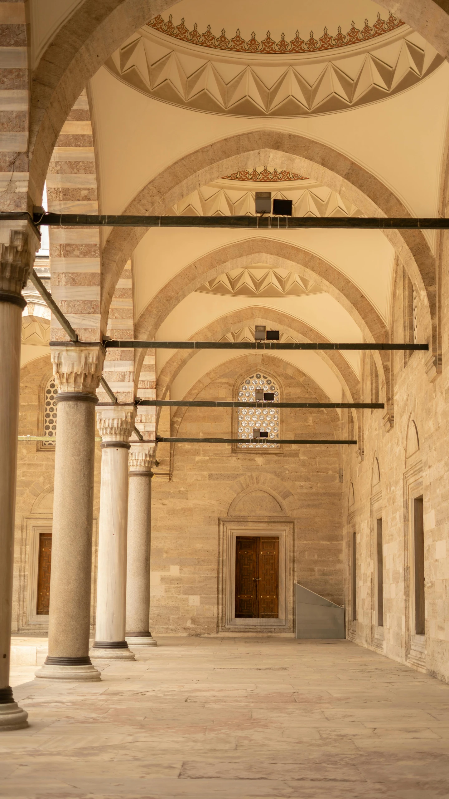 a large ornate building with pillars, and arches