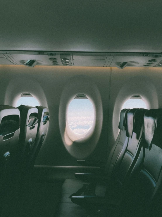 inside an airplane with multiple rows of seats