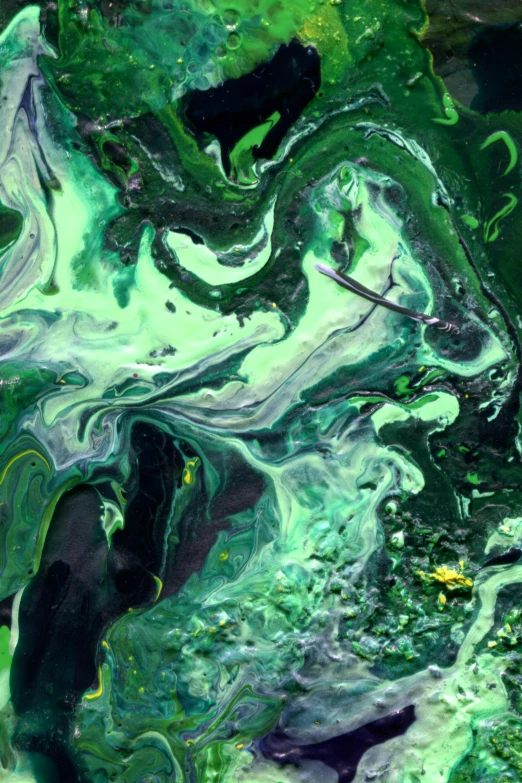 the green swirled paint has been blended into soing black