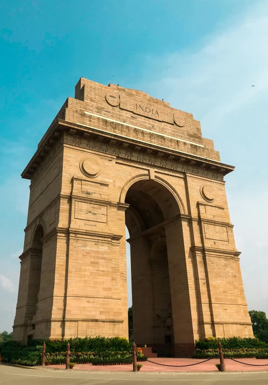 a tall archway on the side of a very big building