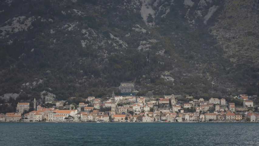 a city on a hillside next to the ocean