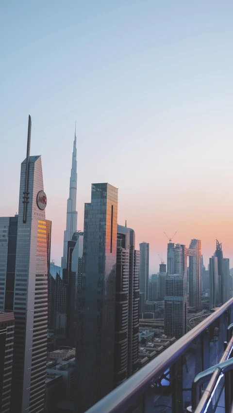 an elevated city skyline has skyscrs and a bridge