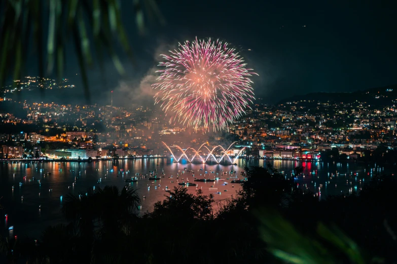 a beautiful fireworks display over the lake at night