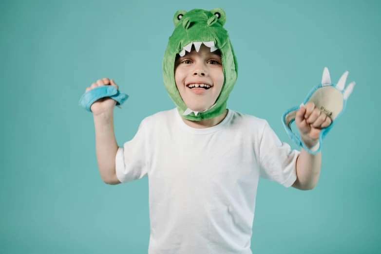 a boy in a hat with one hand holding his head