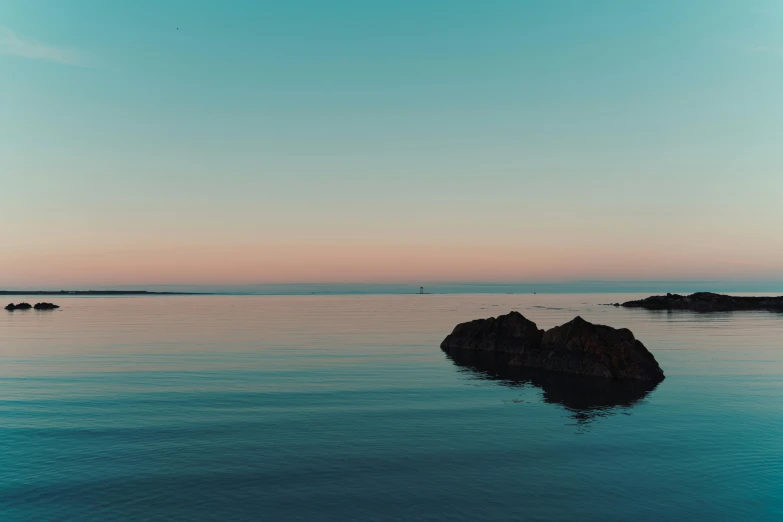 a body of water surrounded by rocks near the shore