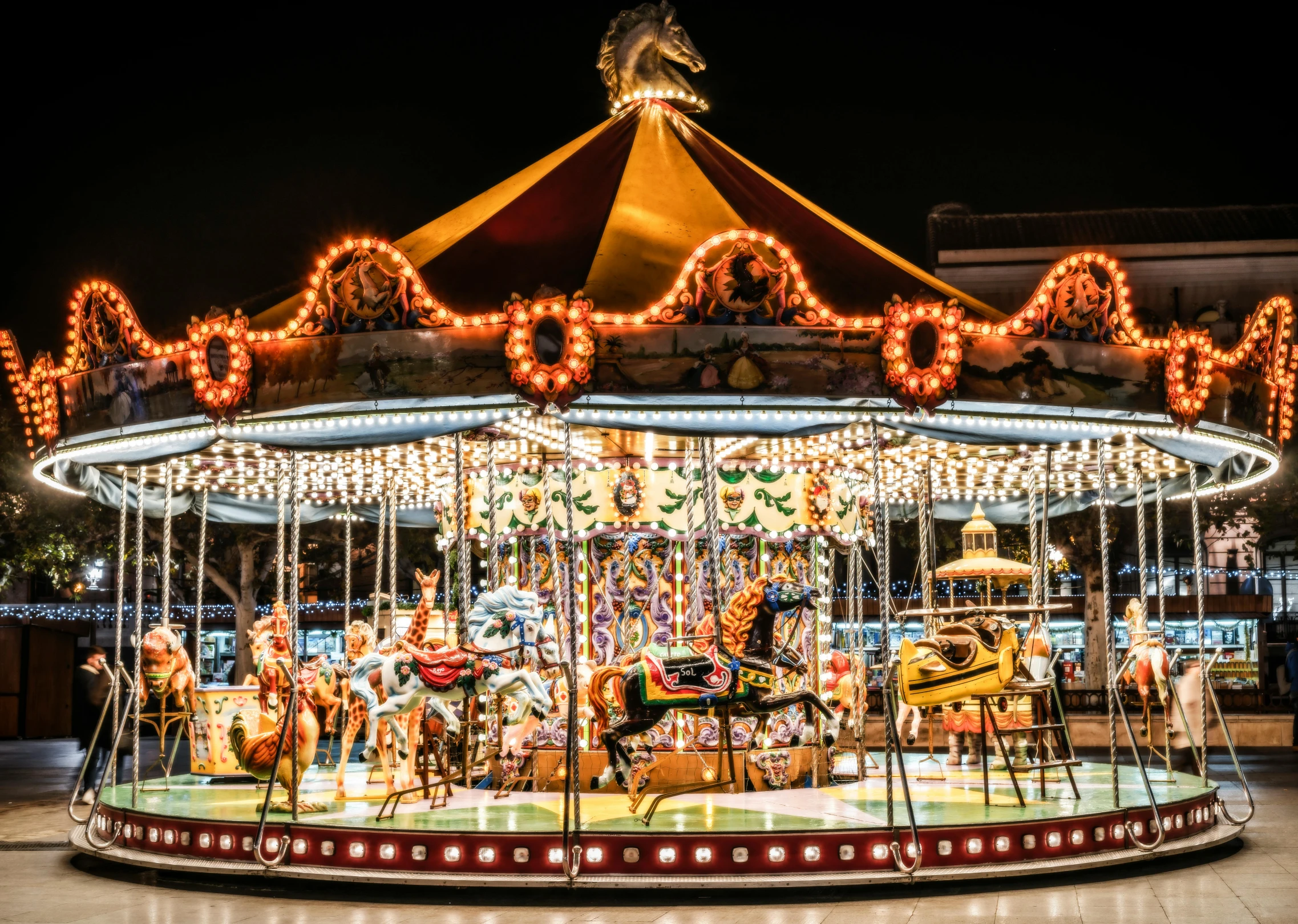 a carousel with lights and a carousel horse