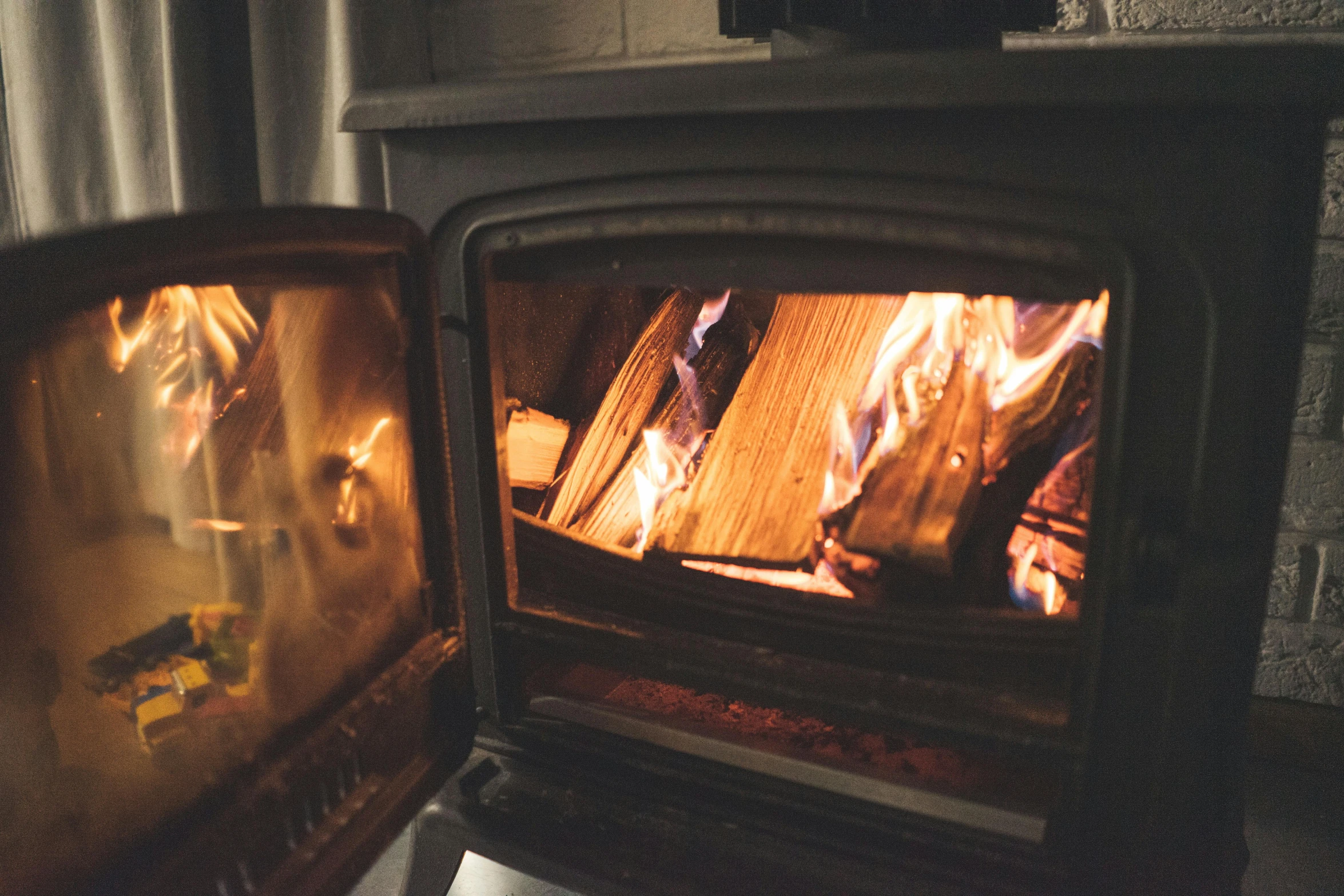 closeup of two wood burnings inside a small oven