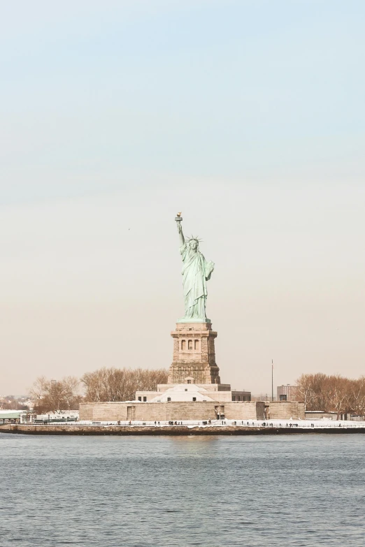 the statue of liberty from across the water