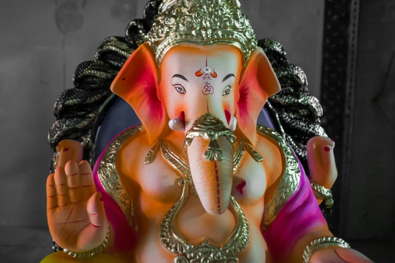 an idol of hindu god and demon is posed in a room