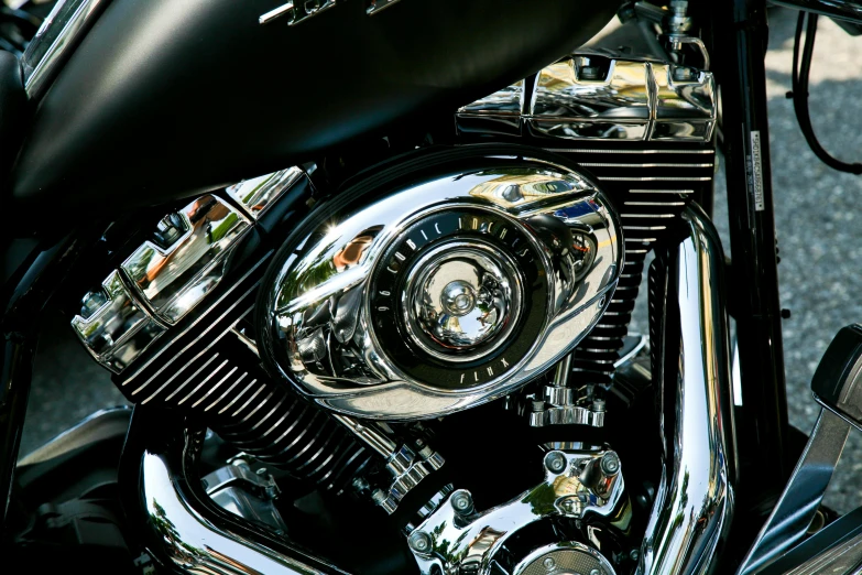 the front end of a motorcycle with chrome and black trim