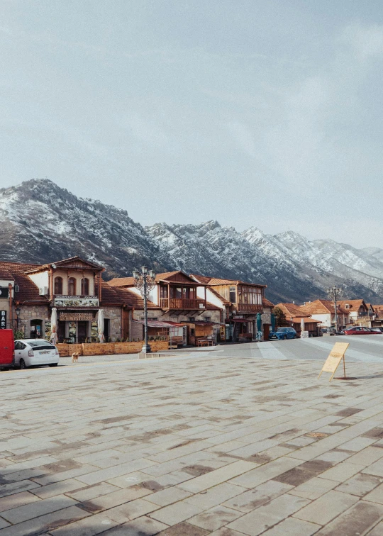 an open walkway in a village near the mountains