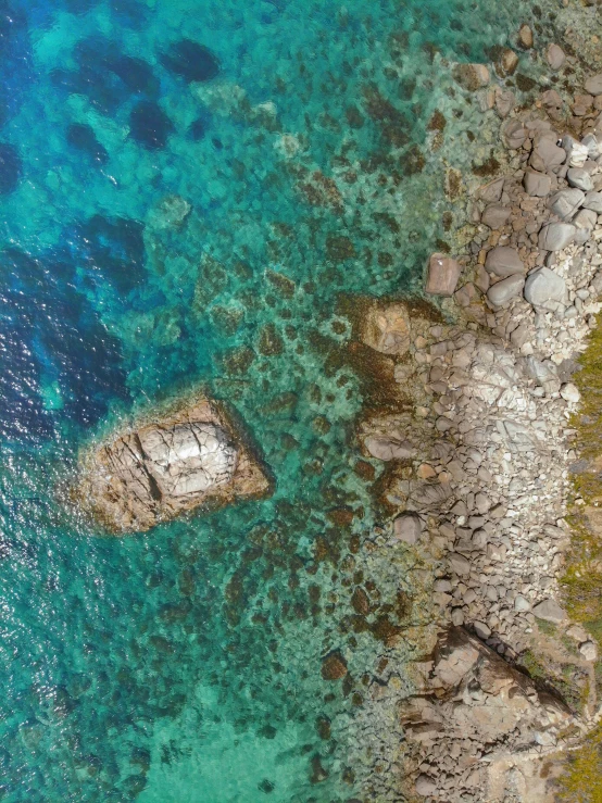 an overhead view of an ocean with blue water