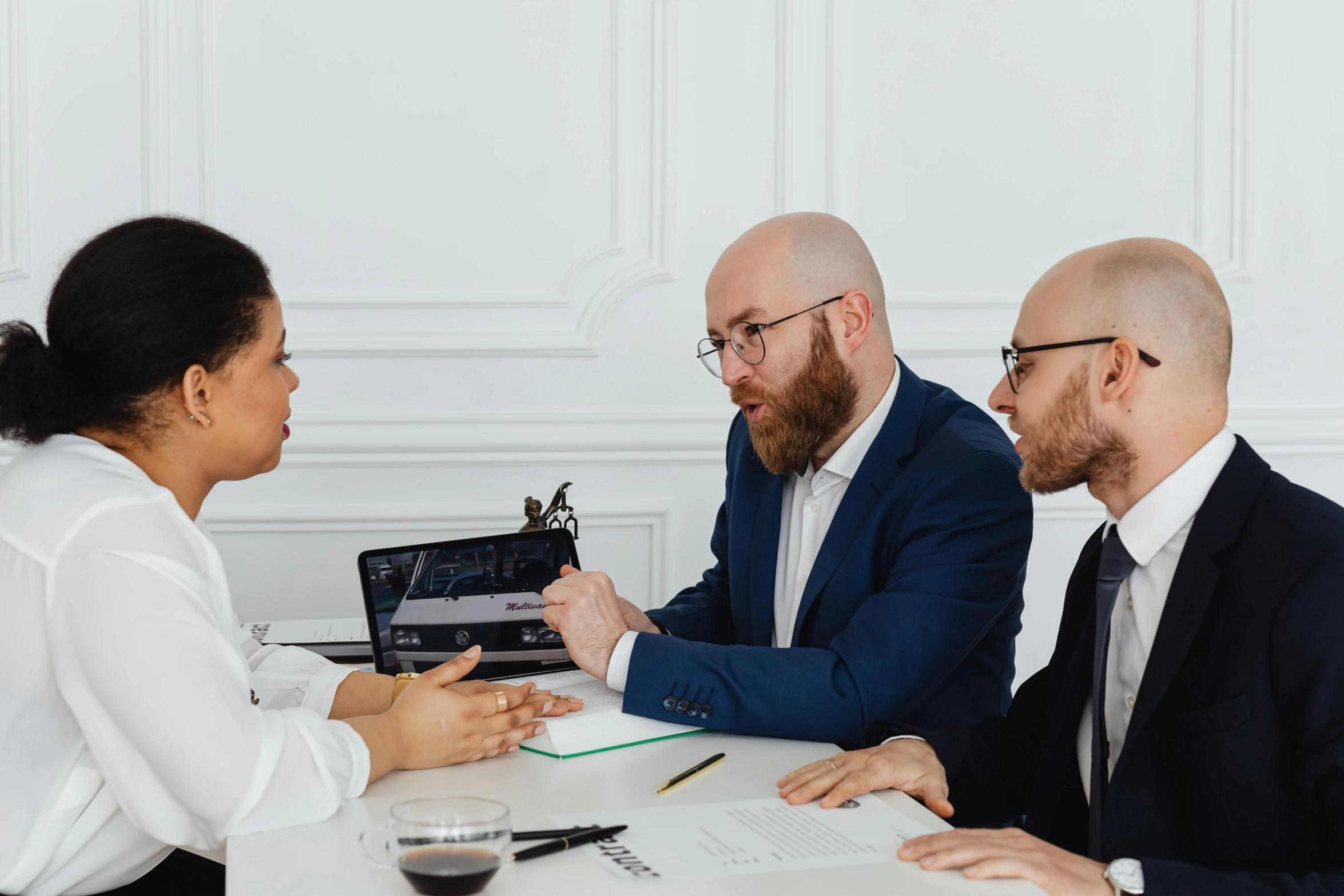 two men and a woman having a business meeting