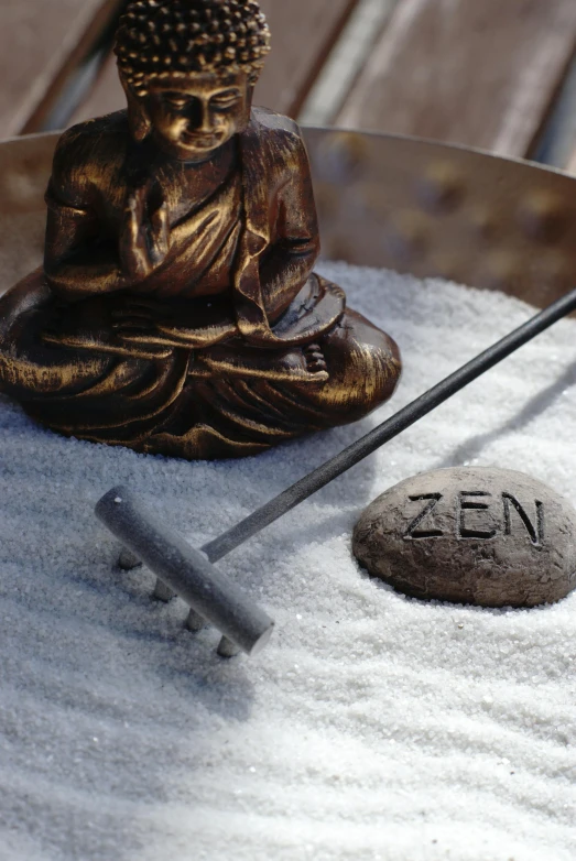 a buddha statue sitting next to a small golf club