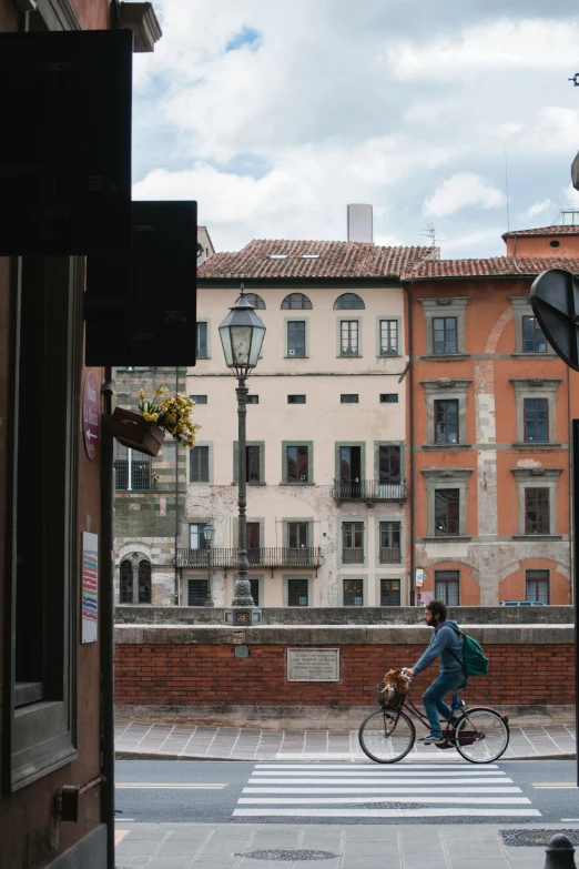 a man on a bicycle going through the town